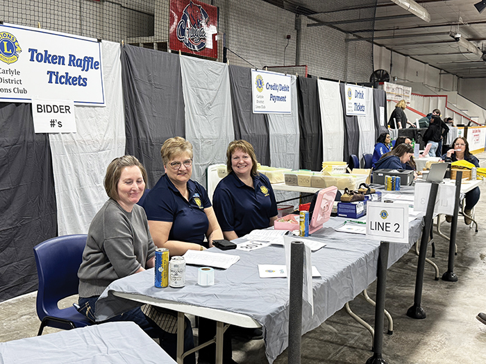 Lions volunteers were everywhere. These members offered raffle tickets and numbers for the live auction.